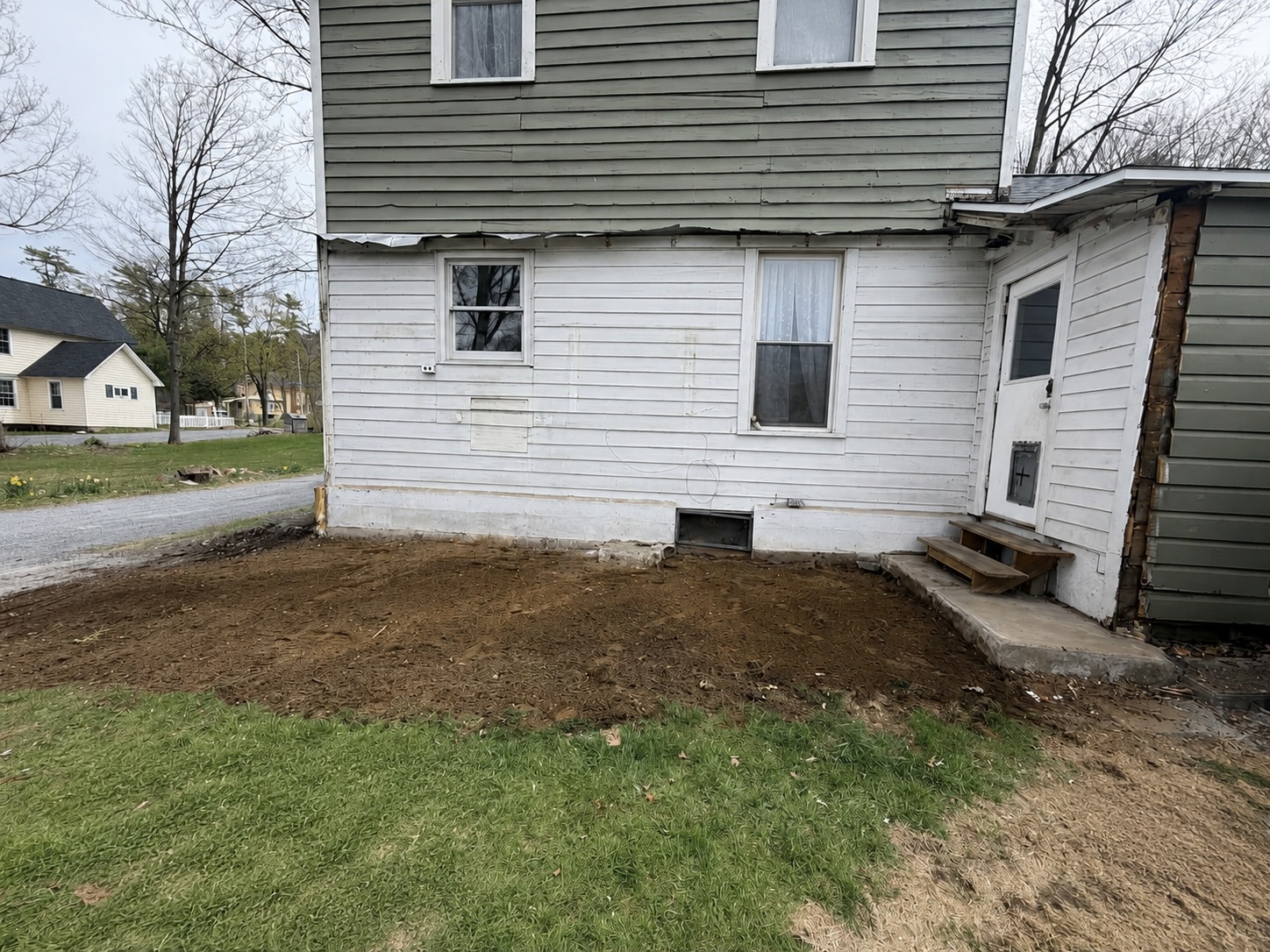 Property after enclosed porch demolition and cleanup